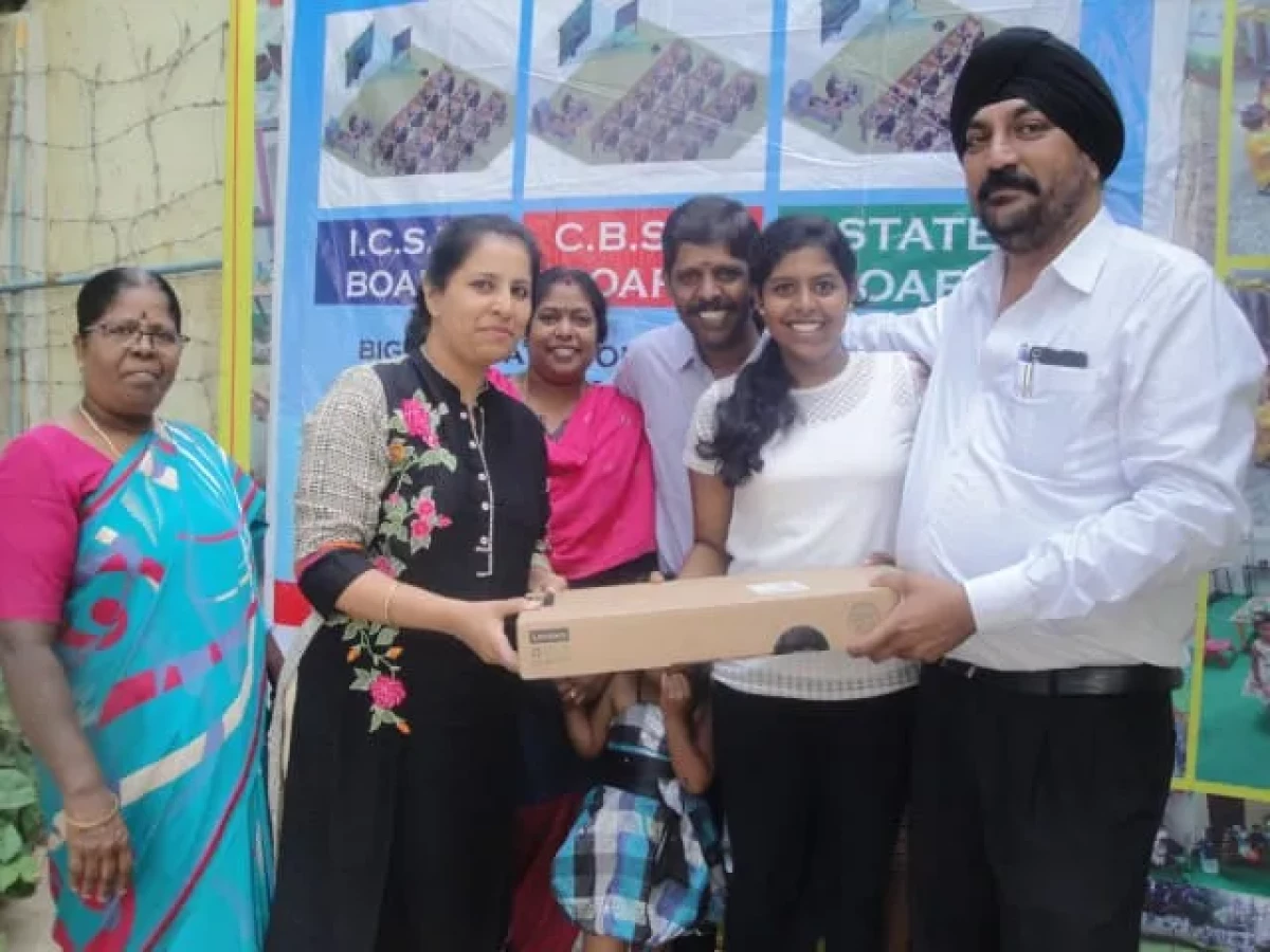 Ankita receiving laptop for scoring 95 percent in 10th State Board exams 2017-18 at Malus Coaching Classes